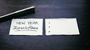 A pen and paper to write New Year's resolutions