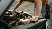 Person looking into car bonnet