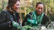 Two people watering plants