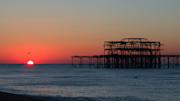 Sunset over a beach and pier