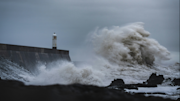 Waves crashing against coastline