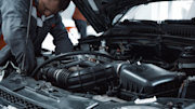 Mechanic looking under a car bonnet