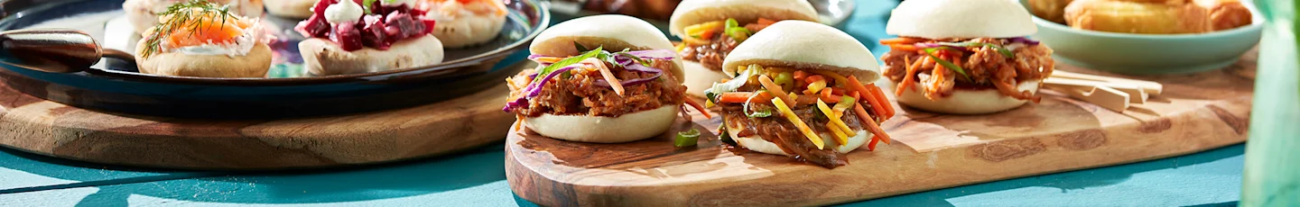Zomers avondeten recepten van gestoomde bao buns met gekruid vlees en kleurrijke groenten, en diverse fingerfoods met onder andere zalm, dille en rode biet.