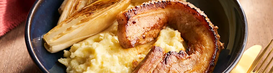 Gestoofde witlof met mandarijn, aardappelpuree en spek