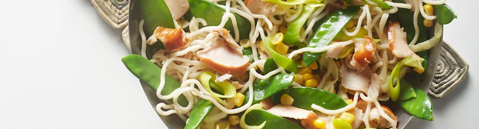 Wokschotel met gerookte kip, mais en peultjes