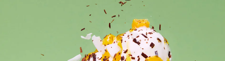 Stracciatella-ijs met mangocoulis en kokossnippers