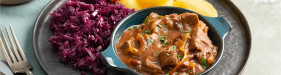 Hachee met rode kool en gekookte aardappelen