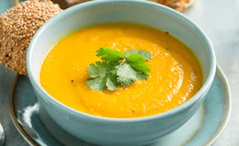 Licht pittige zoete aardappel-wortelsoep met kokosmelk