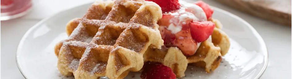 Gesuikerde wafels met hangop en aardbeien