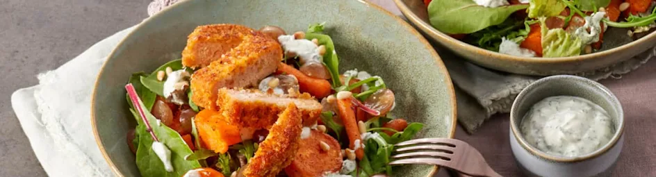 Maaltijdsalade van geroosterde zoete aardappel met gebakken zalmburger