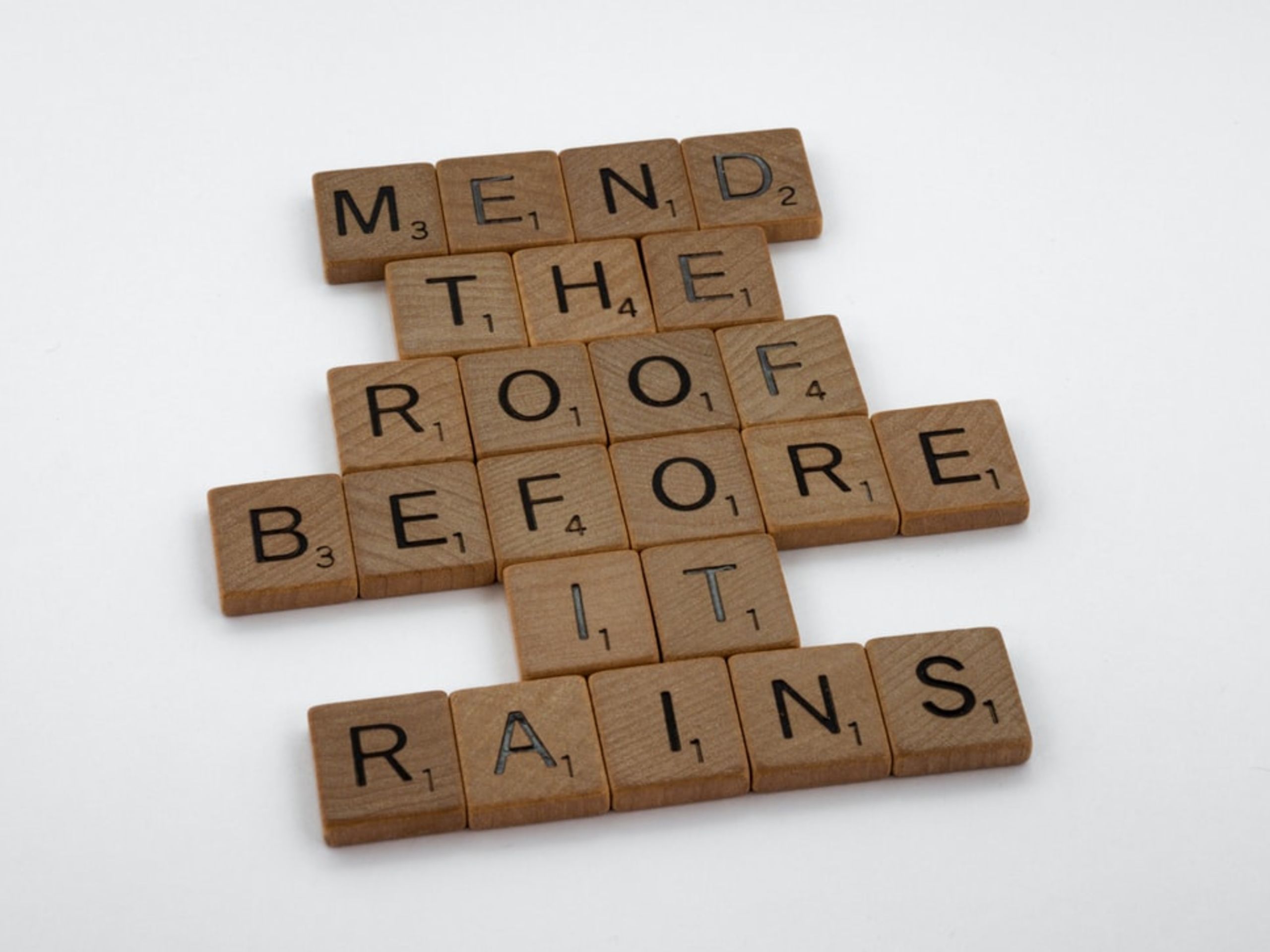 Scrabble letter tiles put together saying "Mend the roof before it rains"