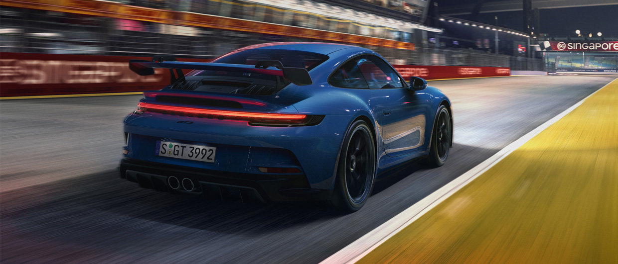 Blue 911 GT3 speeding along racetrack