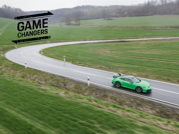 Green Porsche 911 GT3 (type 992) exits hairpin bend