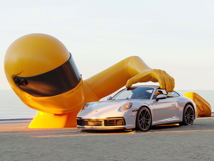 Chris Labrooy sculpture of yellow racing driver and Porsche 911