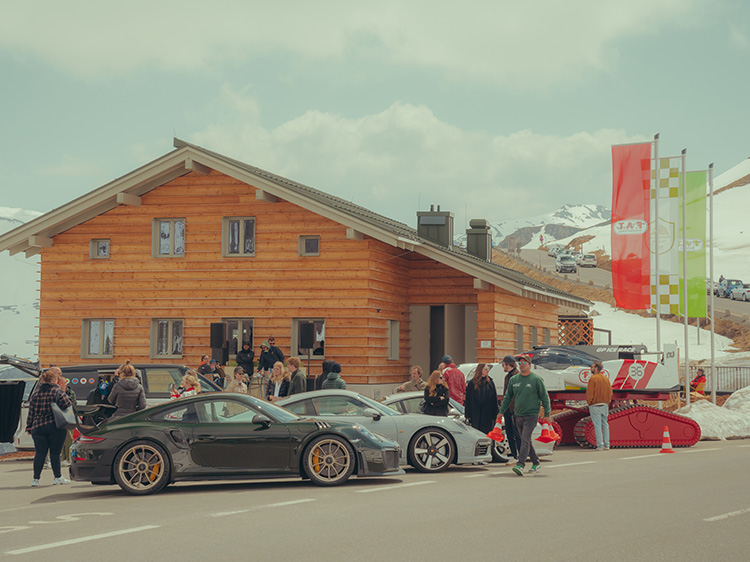 People and Porsche cars outside F.A.T. Mankei, Grossglockner Pass, Austria
