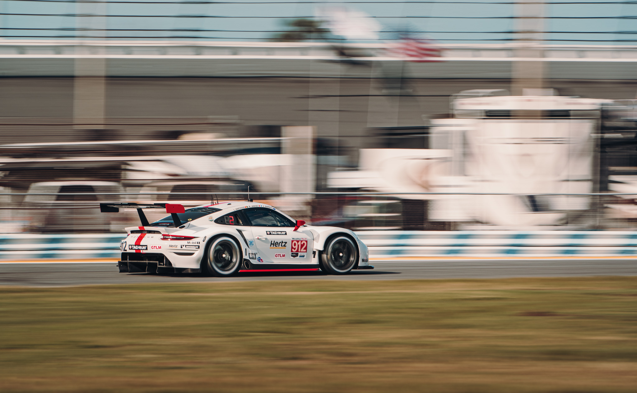 White and red liveried Porsche 911 RSR at Daytona track 