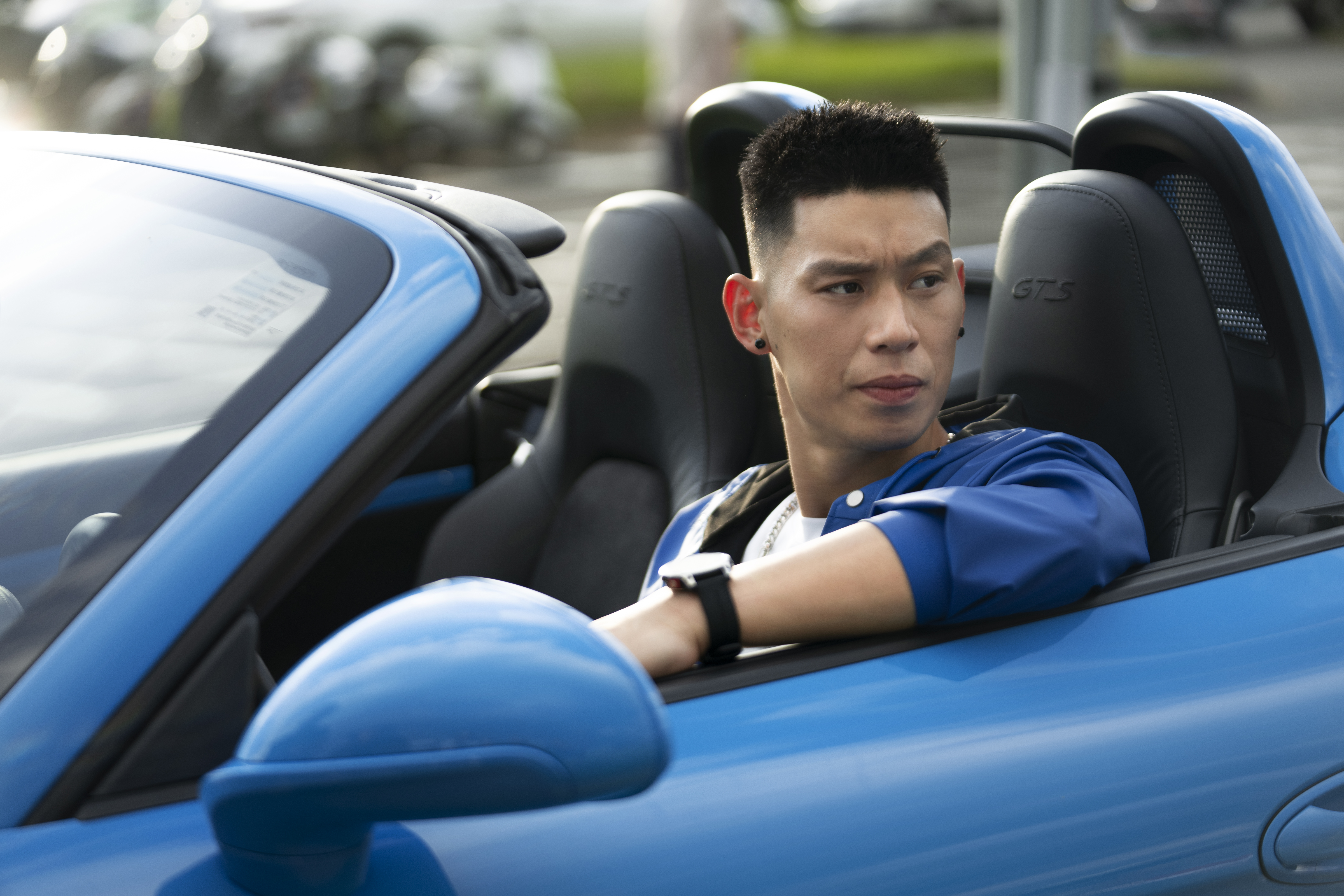 Jeremy Lin sits in Riviera Blue Porsche 718 Boxster GTS