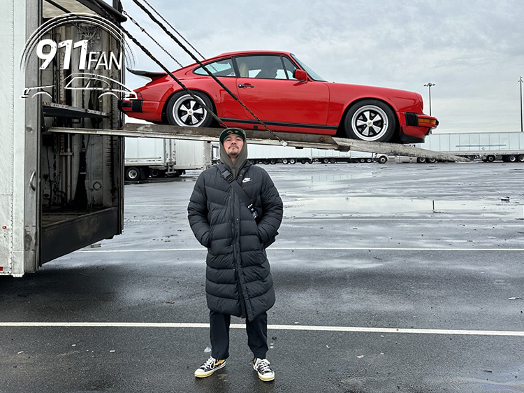 Man standing in front of Porsche 911 in Guards Red