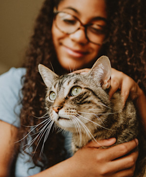 NOW-FRESH-Young-girl-and-grey-cat-snuggling