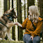 Annika and dog sitting on a log