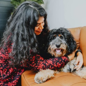Woman hugging dog on a couch