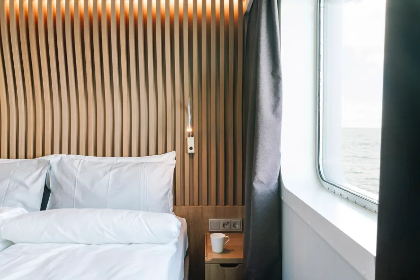 Bedroom in an Arctic Superior: Outside cabin | Upper deck | Accessible (TY) onboard MS Fridtjof Nansen. Credit: Clara Tuma