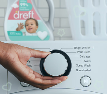 A washing machine with Dreft laundry detergent used to remove stains from children's clothes on it.