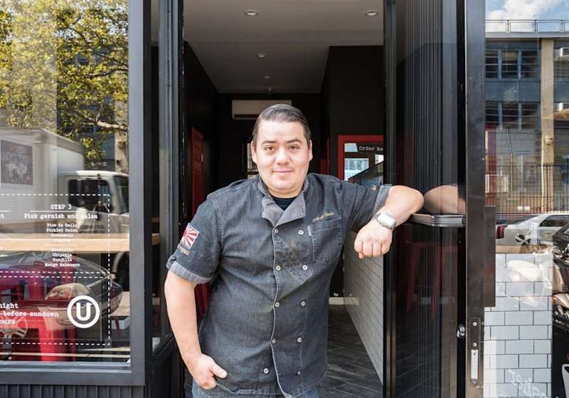 Katsuji Tanabe in front of his restaurant, Mexikosher, in New York.