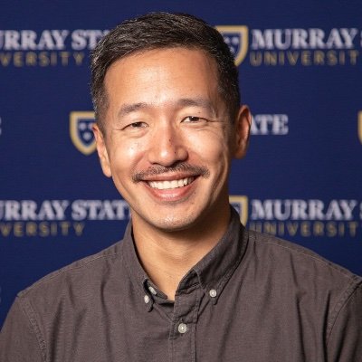 headshot of man with mustache in front of Murray State University banner}}