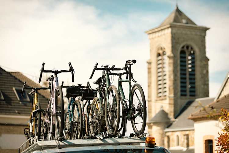 Bikes on car roof with church in background
