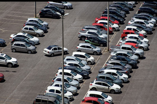 An image showing cars in a parking lot 