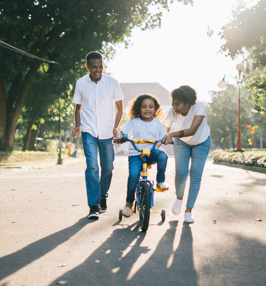 Parents and kid riding bike