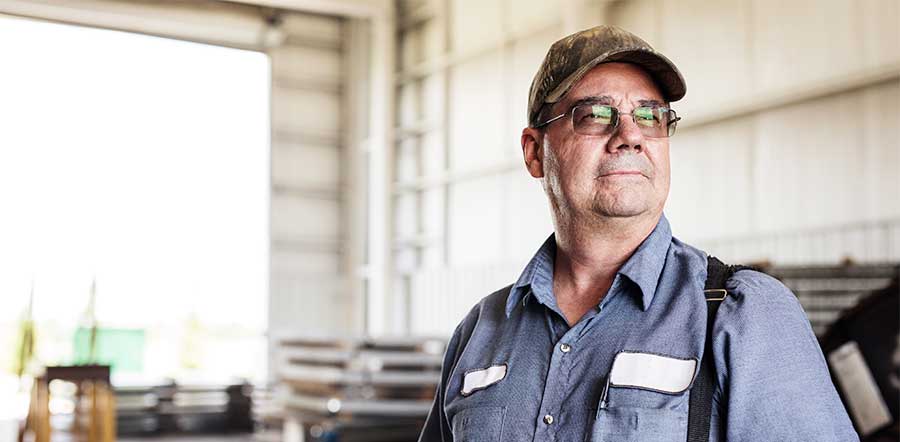 man in garage wearing suspenders