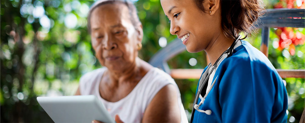 female doctor talking to patient of color