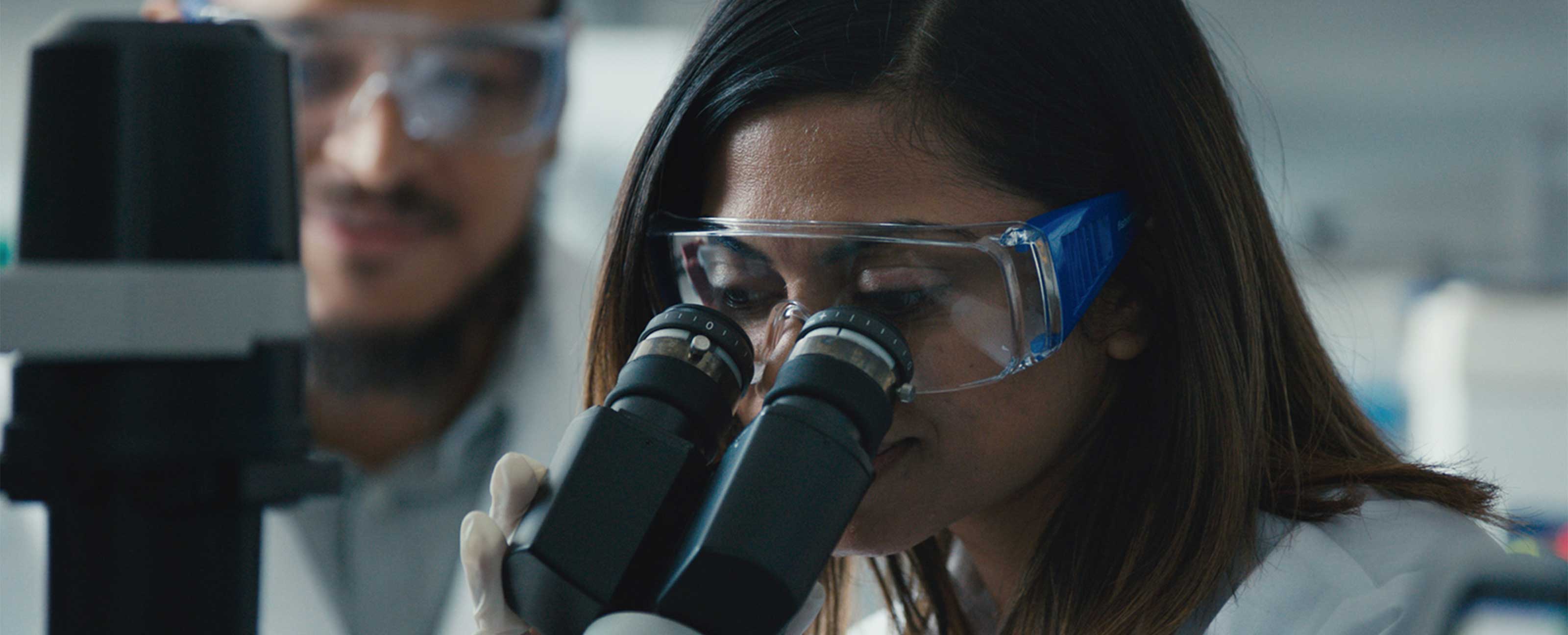 scientist looking in microscope
