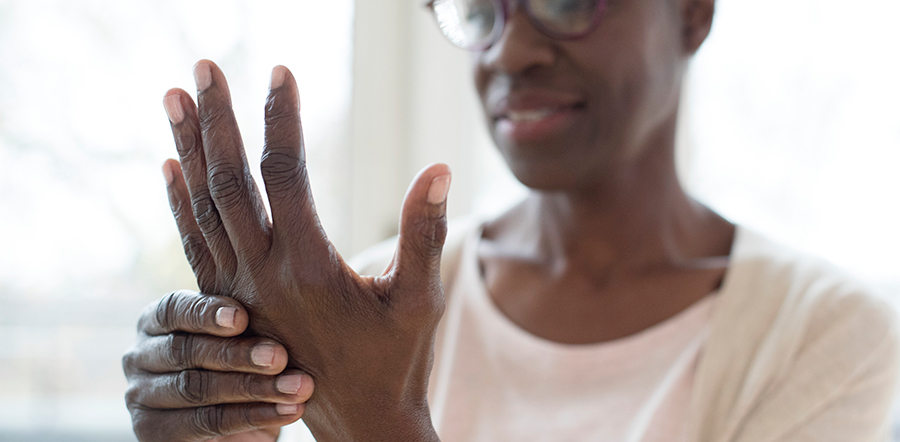 Black woman wringing her hands, which are in focus