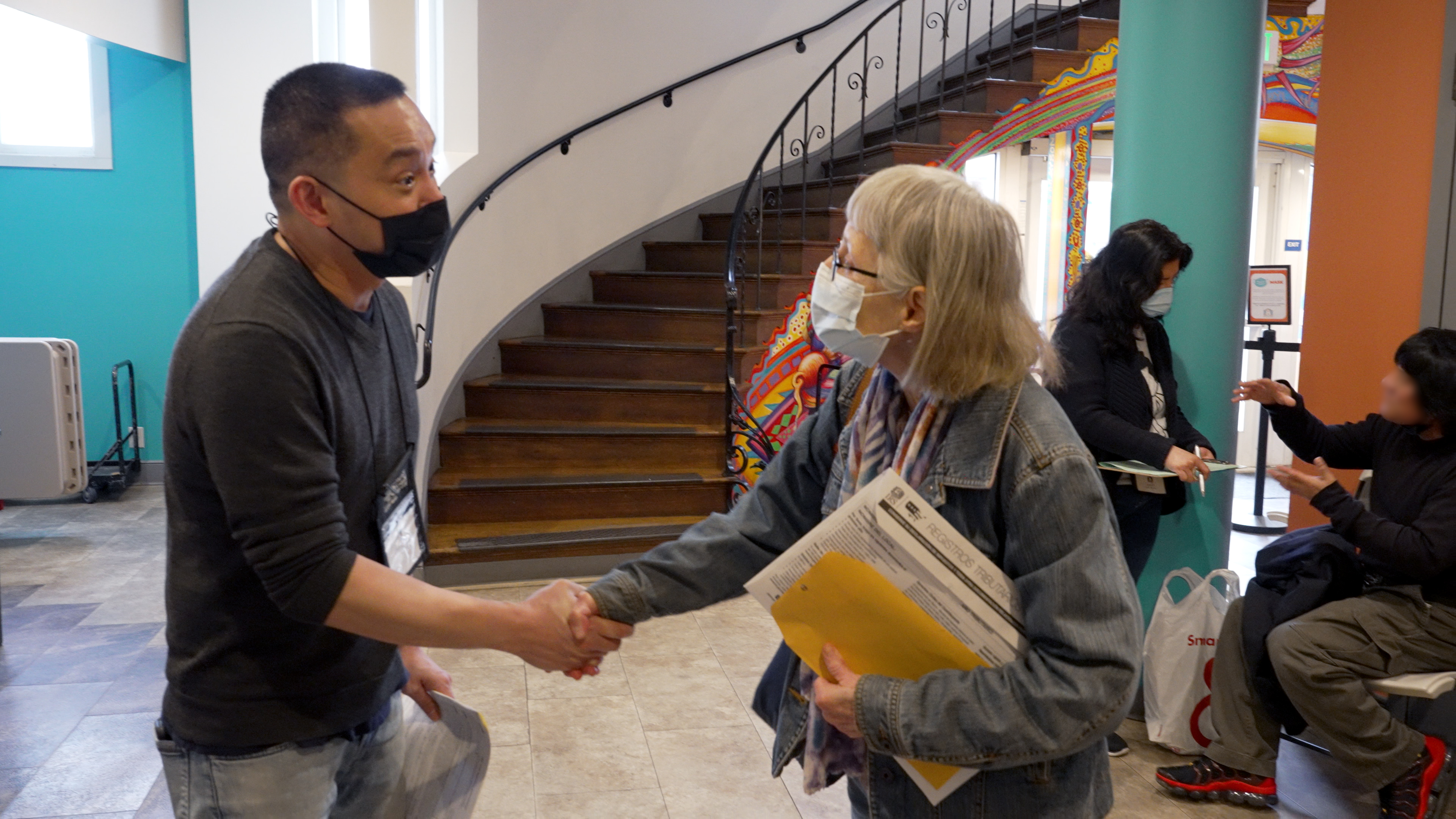Volunteer Tax Preparer shaking hands with Free Tax Help program participant