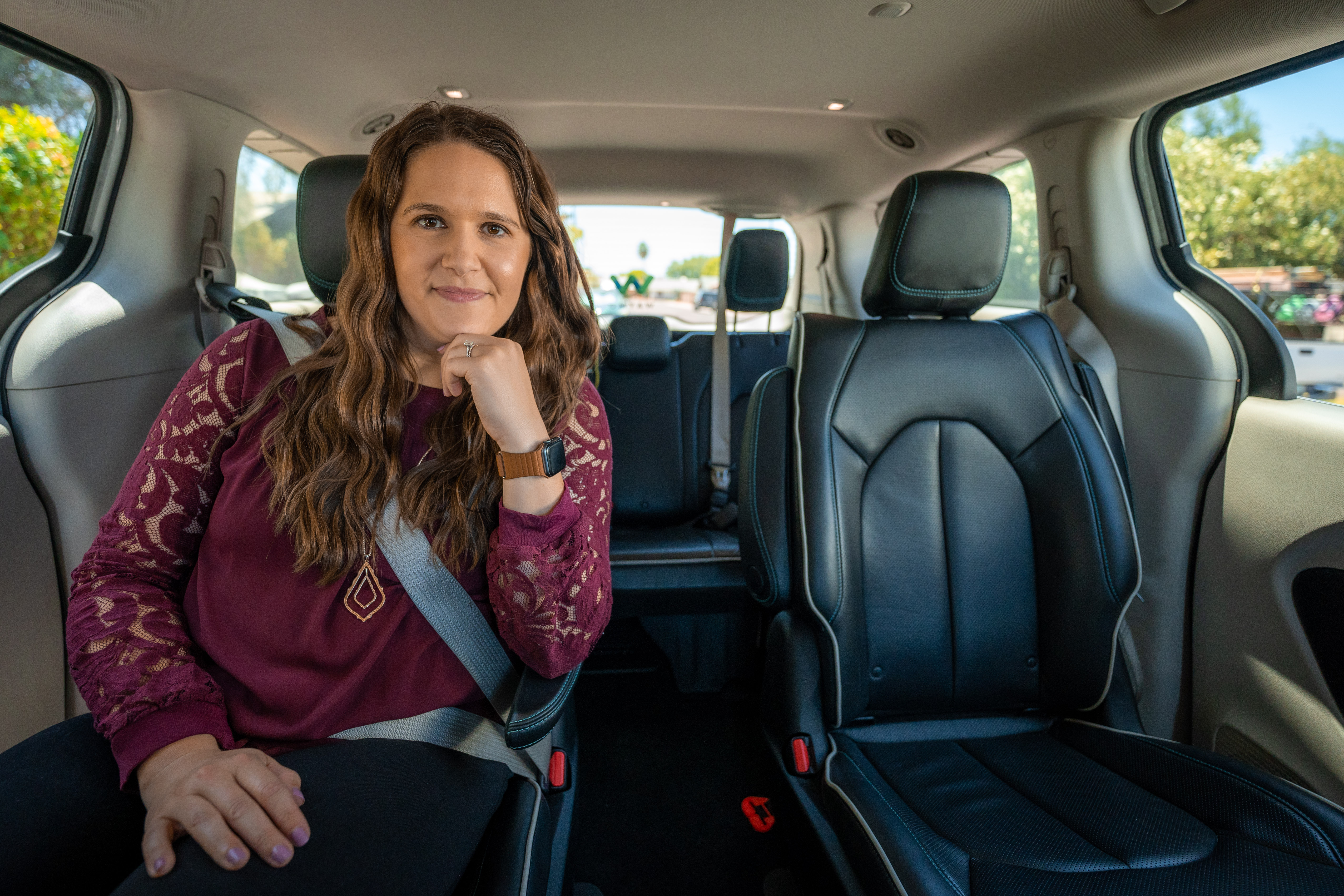Woman sitting in the passenger seat of a Waymo autonomous vehicle
