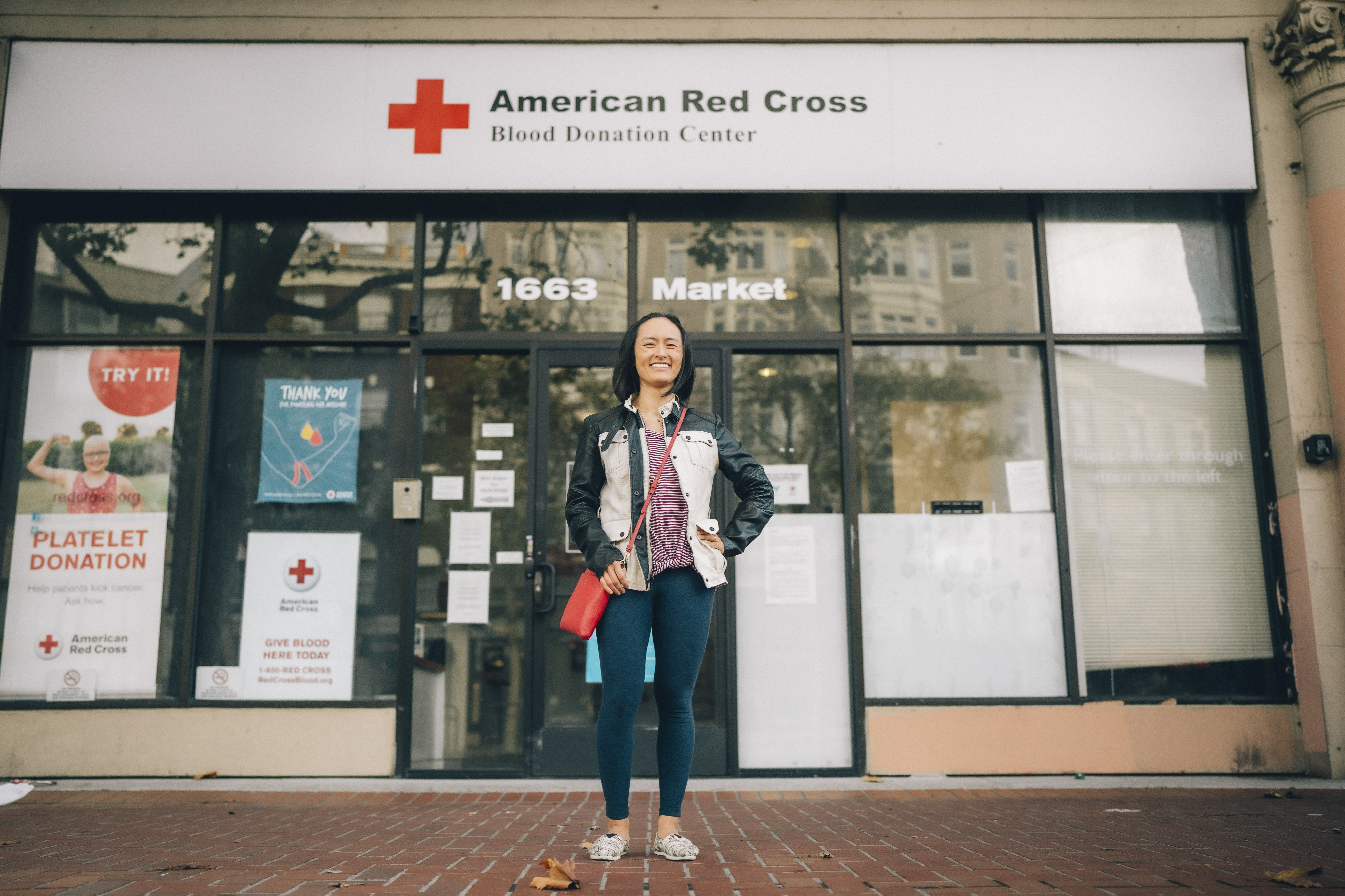 Julie standing in front of the doors to the American Red Cross Blood Donation Center