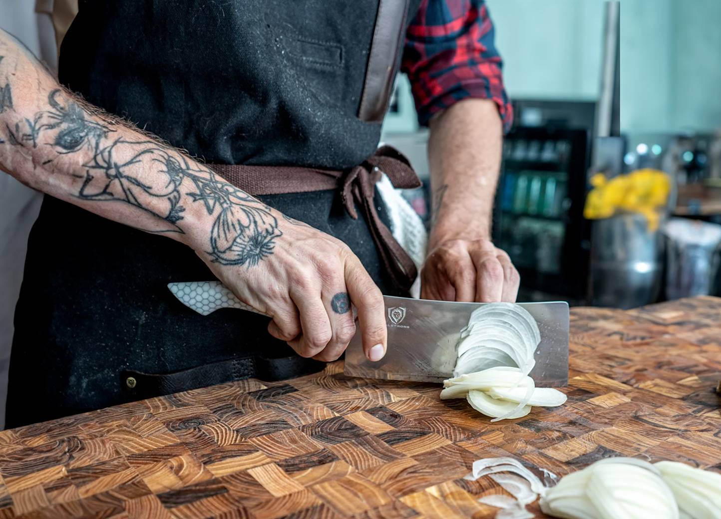 Close up of person cutting a potato with a large knife