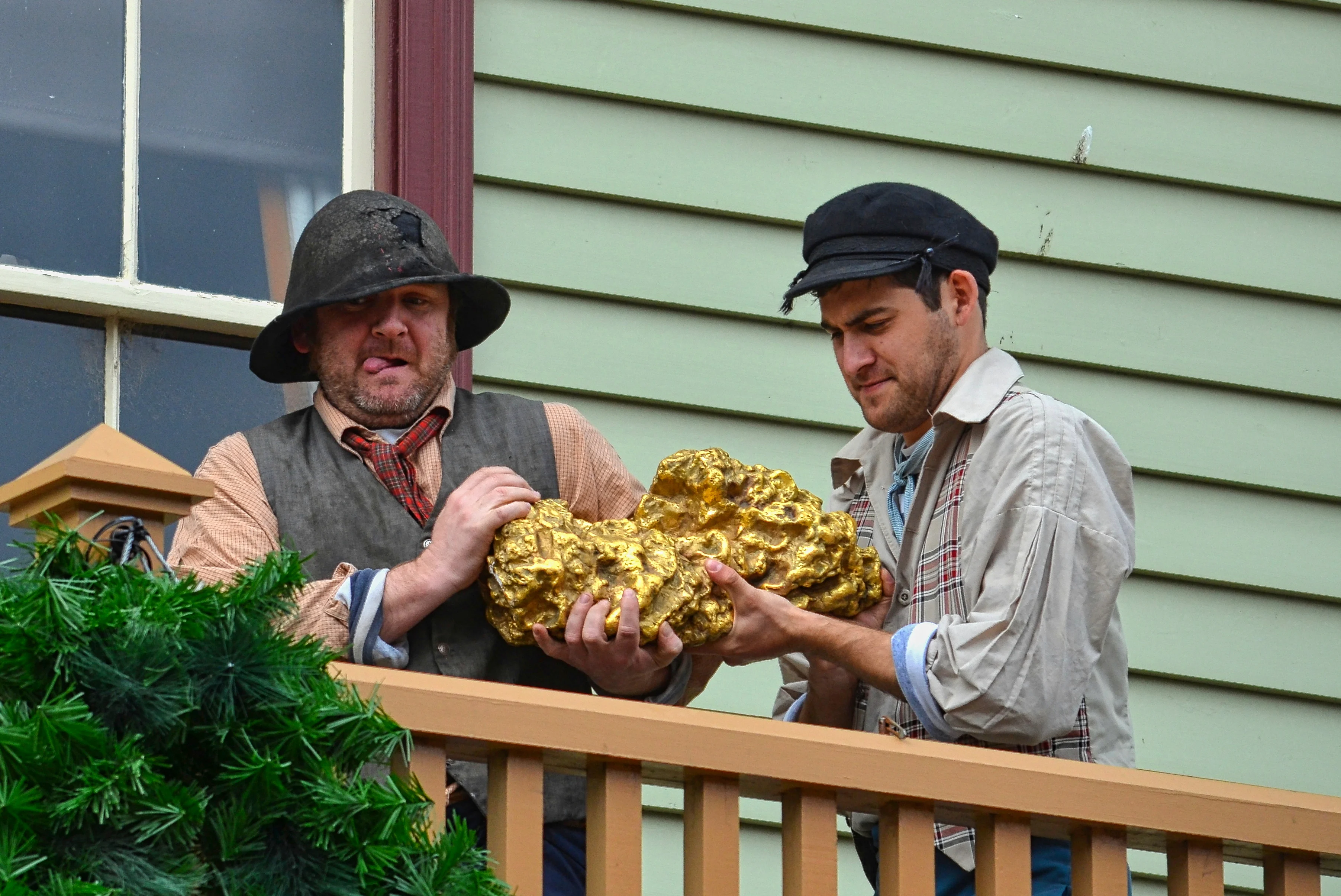 Replica of the Welcome Nugget being carried by two men at Sovereign Hill, Ballarat