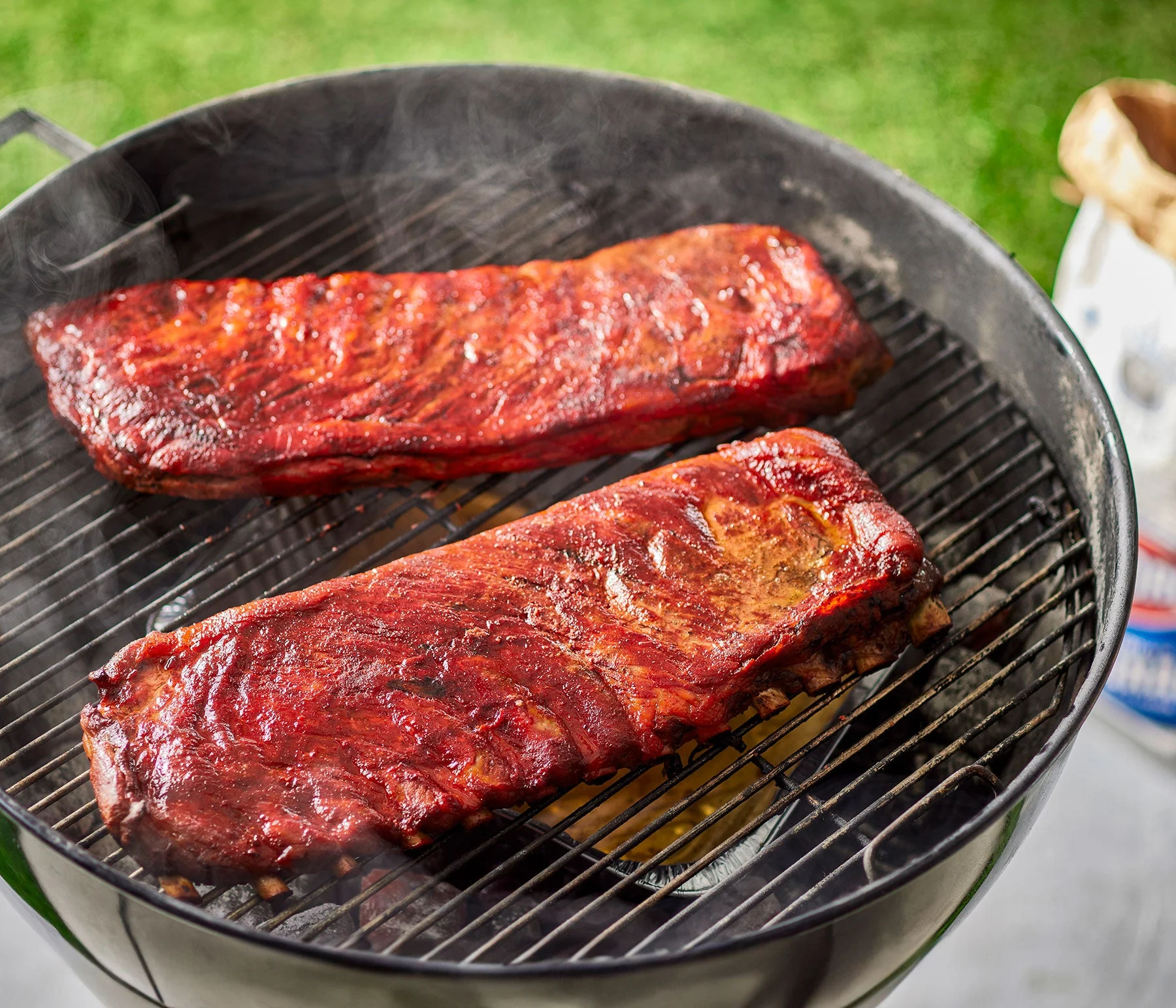 Cherry Kool-Aid Rubbed Ribs cooking on an outdoor grill