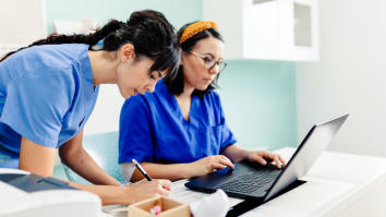 Female apprentice and nurse using the laptop in the hospital