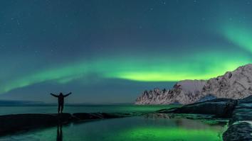 Man watching the northern lights, Aurora Borealis