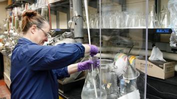 Chemistry graduate mixing chemicals in lab