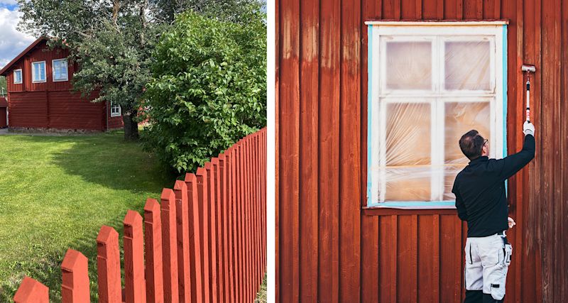 Man målar den röda träfasaden vid inplastat vitt fönster, grön gräsmatta och rött staket.