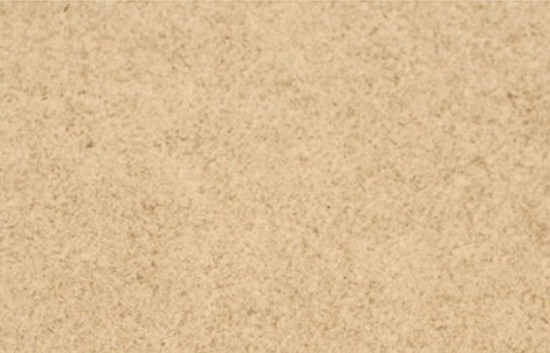 Närbild av finkornig beige sandyta med jämn textur