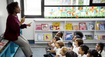 Teacher speaking to young children in a classroom