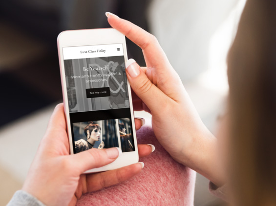 person holding mobile phone showing website