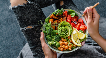 Image of a person eating a colorful salad